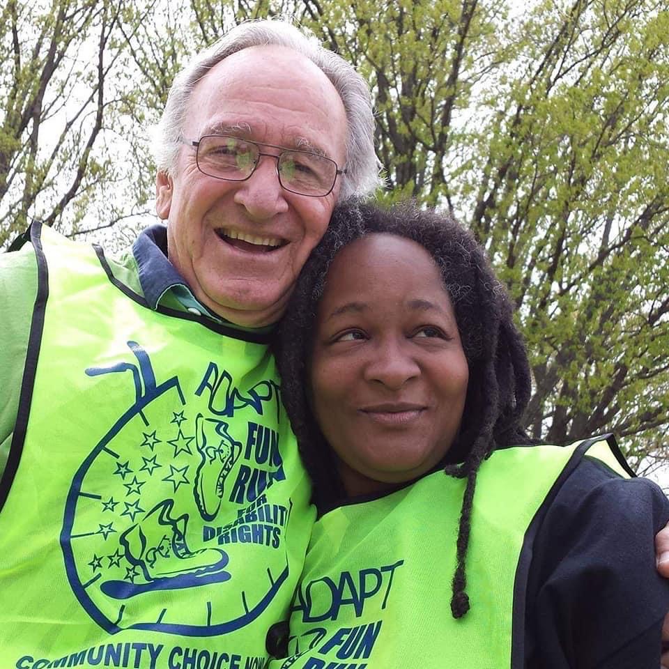 Anita and former Senator Tom Harkin at the ADAPT Fun Run in neon yellow vests.