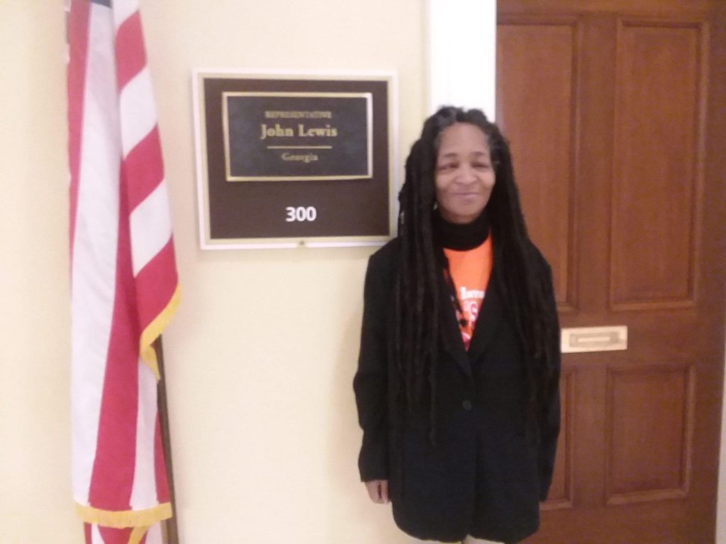 Anita posing in front of John Lewis's DC Congressional Office door.